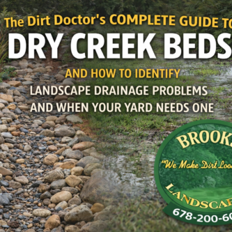 9b712c05-f417-4064-871b-339ad687599b Dry creek bed drainage solution installed by Brooks Landscaping in Paulding County, Georgia to control water runoff and identify landscape drainage problems.