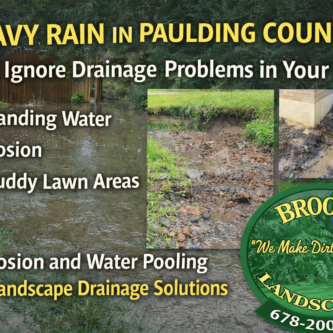 Standing water and erosion in backyard after rain showing landscape drainage problem solved by Brooks Landscaping in Paulding County Georgia.